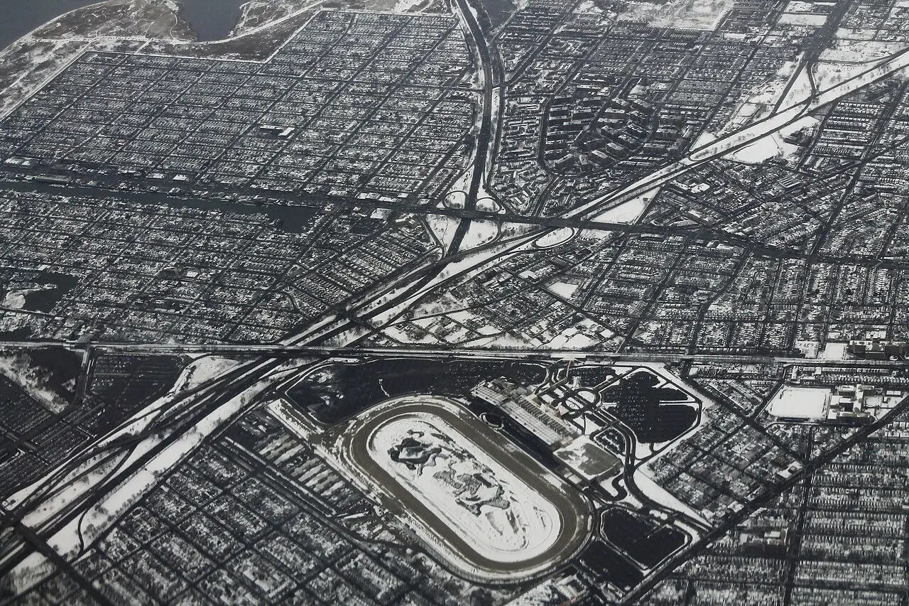 Aerial photograph of snow-covered Aqueduct Racetrack, expressways and the surrounding Queens street grid in 2013