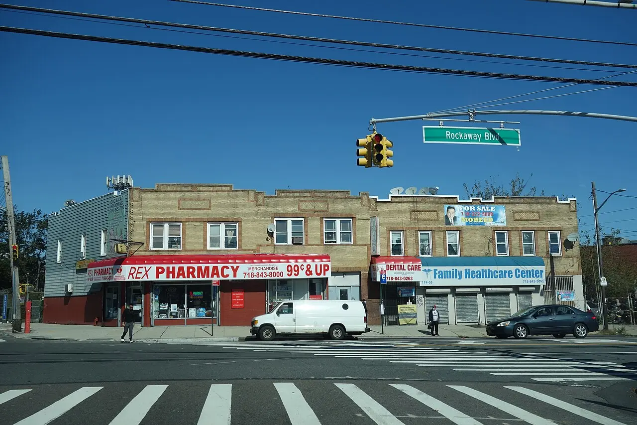 Photograph of the 1930-built low-rise shop building at Rockaway Boulevard and Lefferts Boulevard in 2020